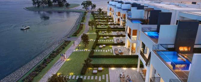 Modern Lake Norman townhomes at sunset with terraces, pools, and landscaped gardens overlooking serene water, boat in the distance.
